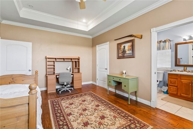 17444 16th Hwy, Siloam Springs, AR 72761 - bedroom featuring light wood-style flooring, an office area, crown molding, a tray ceiling, and baseboards