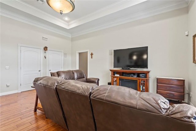 17444 16th Hwy, Siloam Springs, AR 72761 - living area featuring light wood-style floors, baseboards, crown molding, and a tray ceiling