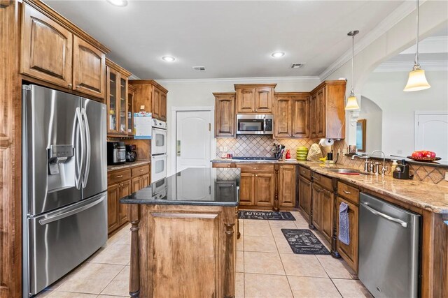 17444 16th Hwy, Siloam Springs, AR 72761 - kitchen with stainless steel appliances, arched walkways, light tile patterned flooring, a sink, and crown molding
