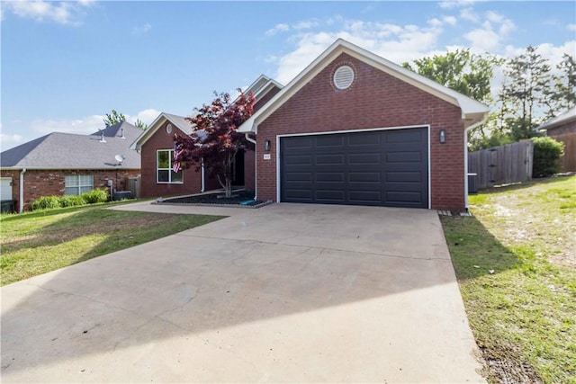 view of front of house featuring a front lawn, driveway, and brick siding