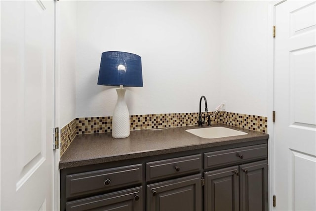 bathroom with decorative backsplash and a sink