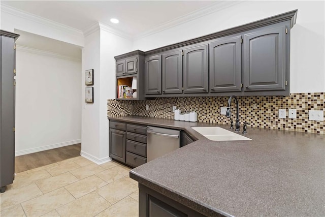 kitchen with dishwasher, dark countertops, tasteful backsplash, and a sink