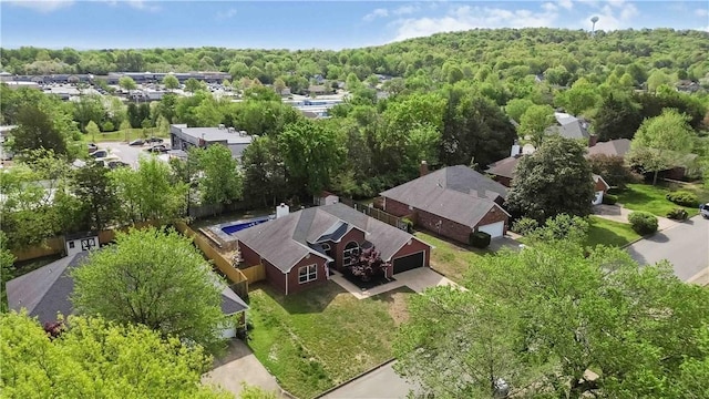 birds eye view of property with a view of trees