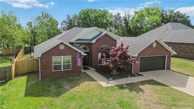 view of front facade with fence, a front lawn, concrete driveway, brick siding, and a garage