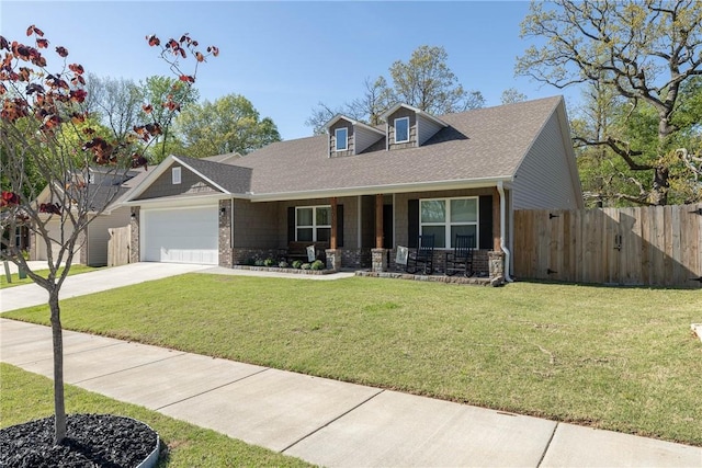 view of front of property with a garage, a porch, a front yard, and fence
