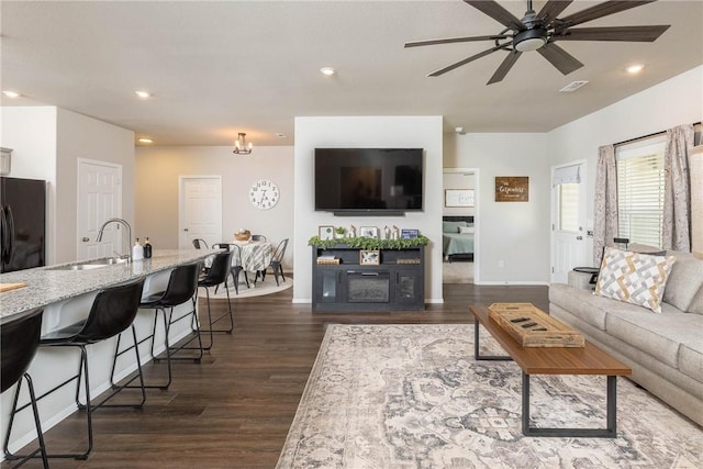 living room with baseboards, recessed lighting, dark wood-type flooring, and ceiling fan