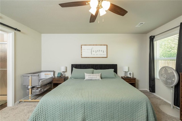 carpeted bedroom with visible vents, baseboards, and ceiling fan