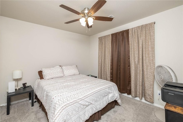 carpeted bedroom featuring ceiling fan and baseboards
