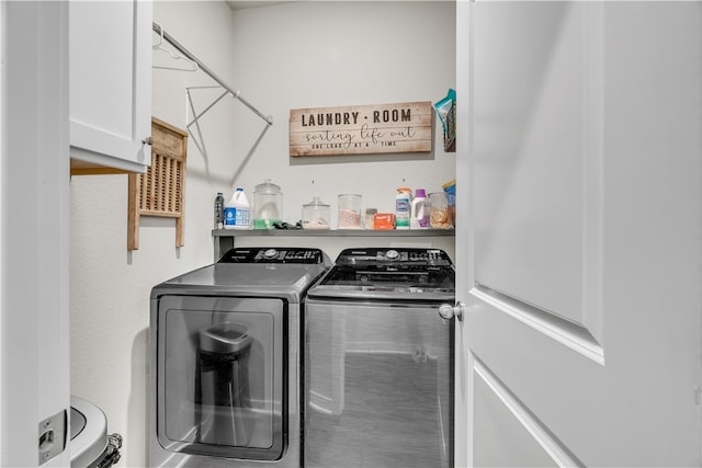 washroom featuring cabinet space and washing machine and clothes dryer