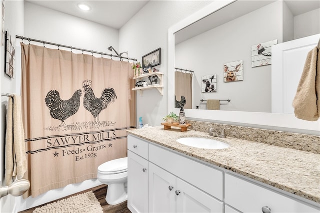 full bath featuring recessed lighting, wood finished floors, toilet, and vanity
