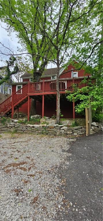 exterior space with stairway and a wooden deck