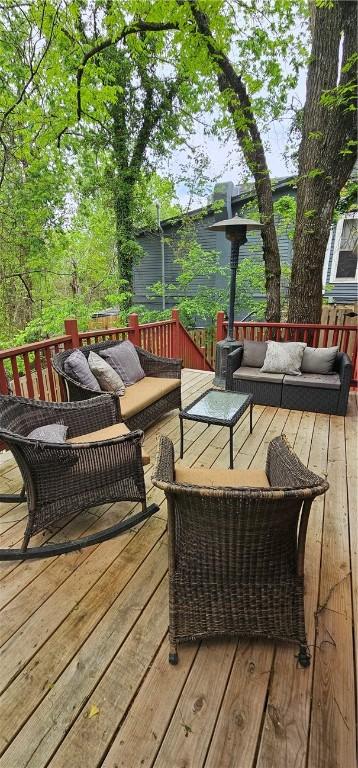 wooden terrace with an outdoor living space