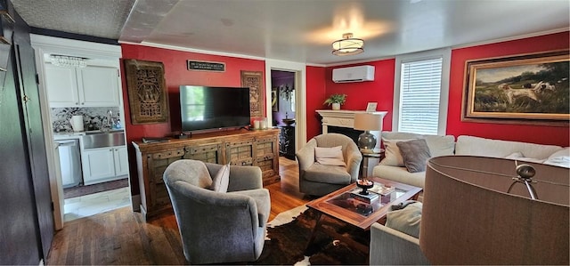living area with a wall mounted air conditioner and wood finished floors