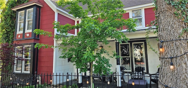 exterior space featuring an attached garage and fence