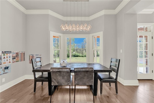 dining room with baseboards, a chandelier, wood finished floors, and plenty of natural light