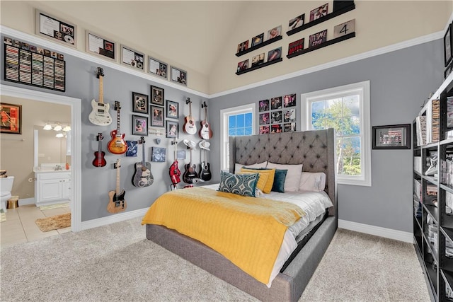 carpeted bedroom featuring high vaulted ceiling, baseboards, connected bathroom, and tile patterned floors
