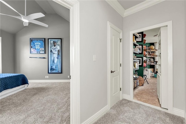 carpeted bedroom with a ceiling fan, baseboards, and ornamental molding
