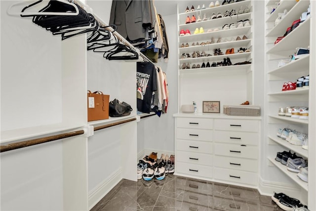 spacious closet featuring marble finish floor