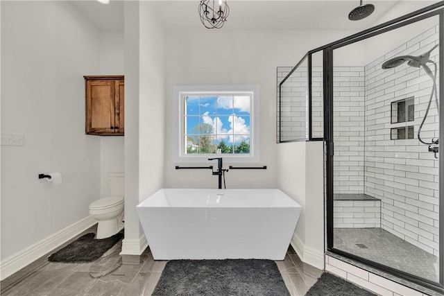 full bathroom with a soaking tub, baseboards, a shower stall, and toilet