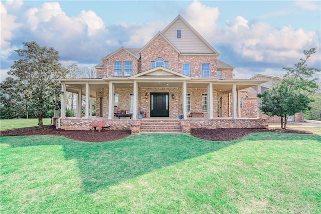 view of front facade featuring covered porch, brick siding, and a front yard