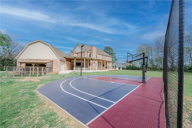 view of sport court featuring community basketball court, fence, and a yard