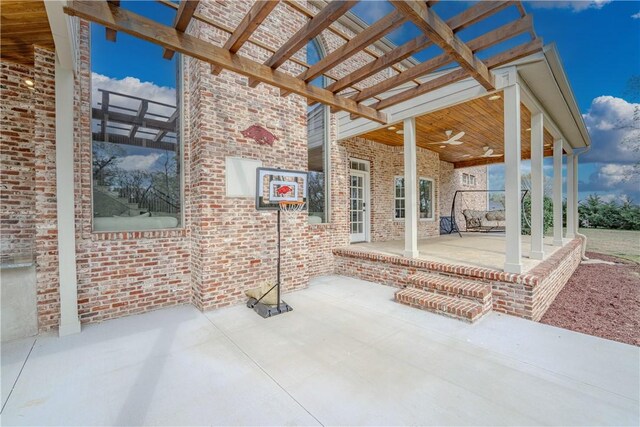 view of patio / terrace featuring a pergola and a ceiling fan
