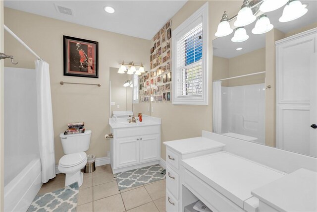 full bath featuring tile patterned floors, vanity, a chandelier, shower / tub combo with curtain, and toilet