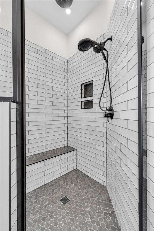 full bath featuring a tile shower