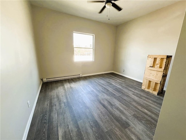 spare room with a baseboard radiator, baseboards, dark wood-style flooring, and ceiling fan