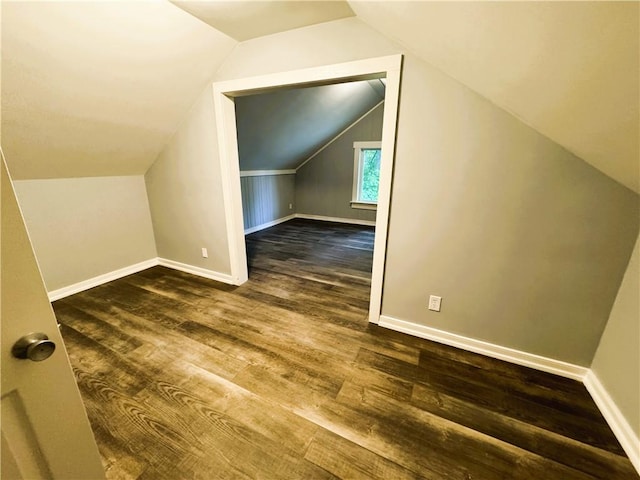 bonus room with lofted ceiling, baseboards, and wood finished floors