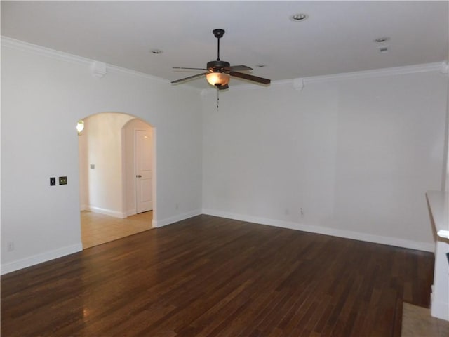 unfurnished room with ornamental molding, arched walkways, a ceiling fan, and wood finished floors