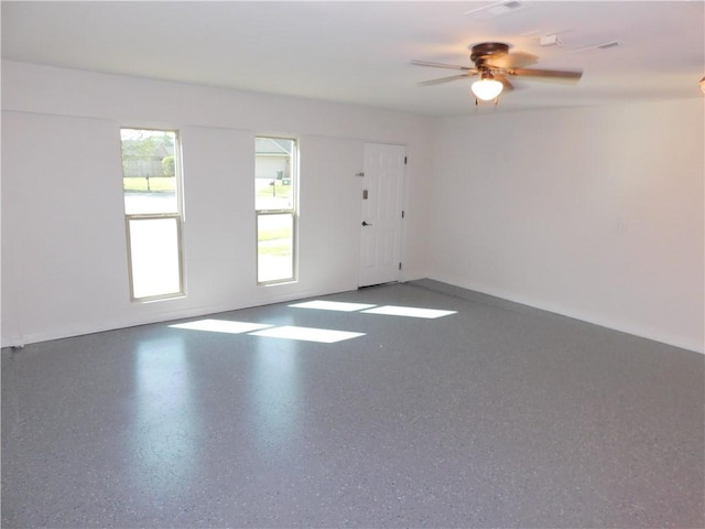 empty room with baseboards and ceiling fan