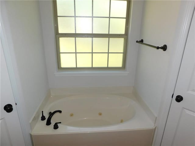 bathroom featuring a tub with jets