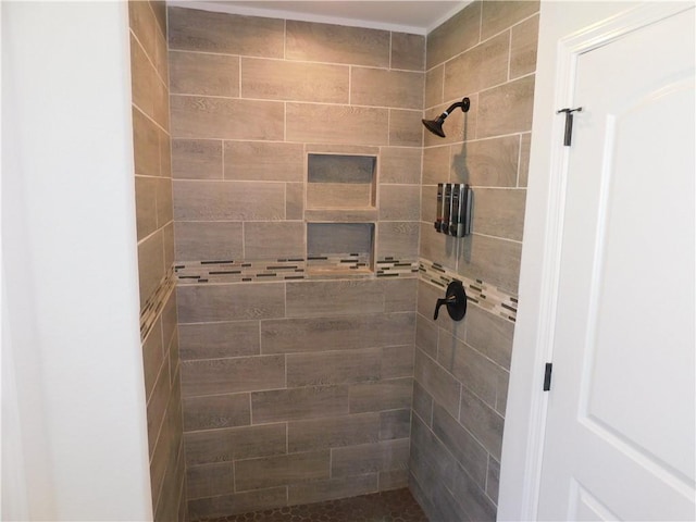 bathroom with a tile shower