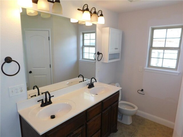 full bath featuring tile patterned flooring, a sink, double vanity, and toilet