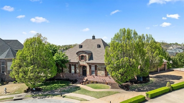 5309 S Promontory Ct, Rogers, AR 72758 - french provincial home featuring stone siding, brick siding, concrete driveway, and a garage