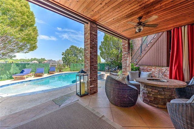 5309 S Promontory Ct, Rogers, AR 72758 - fenced backyard with an outdoor fire pit, a patio area, and a ceiling fan