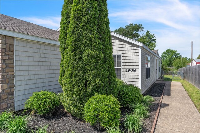 1908 S Pinewoods Dr, Rogers, AR 72758 - view of side of property featuring fence and a shingled roof
