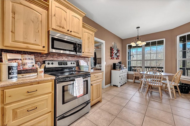 kitchen with backsplash, light brown cabinets, light tile patterned floors, a chandelier, and appliances with stainless steel finishes