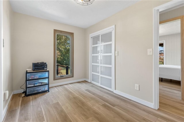 interior space featuring light wood finished floors and baseboards