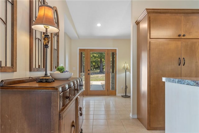 entryway featuring recessed lighting, baseboards, and light tile patterned floors