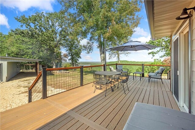wooden deck with outdoor dining space