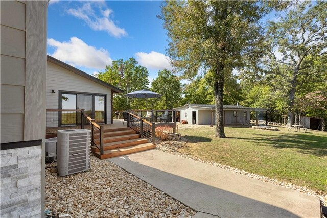 view of front facade featuring a wooden deck, a front yard, and central air condition unit