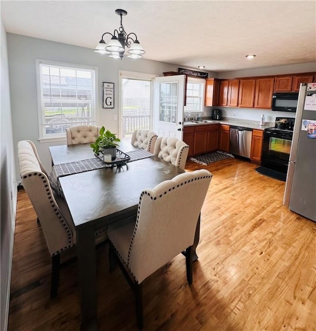 dining room with a chandelier and light wood-type flooring