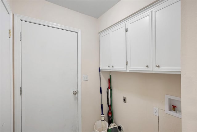 clothes washing area with electric dryer hookup, cabinet space, and washer hookup