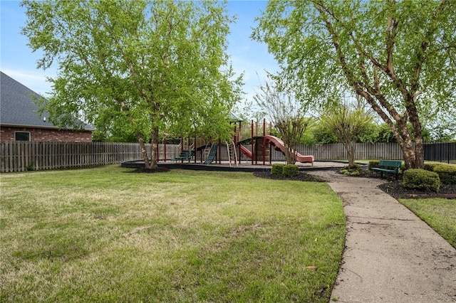 view of yard with fence and a playground
