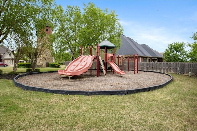 community jungle gym featuring fence and a yard