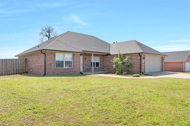 ranch-style home featuring brick siding, an attached garage, driveway, and fence