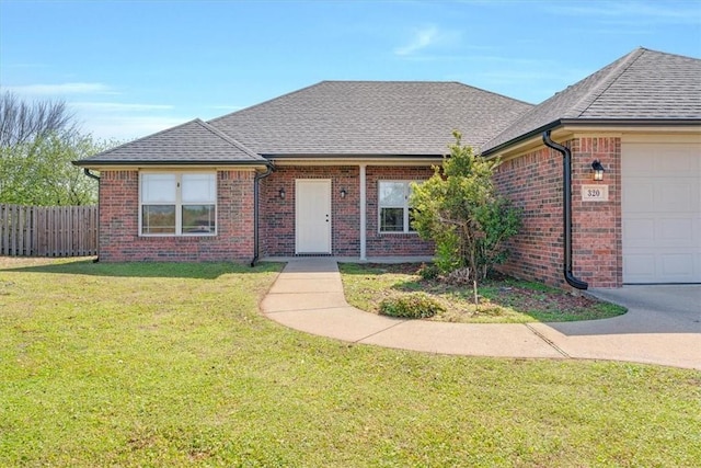 single story home with a shingled roof, an attached garage, fence, a front yard, and brick siding