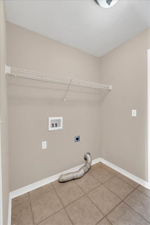 clothes washing area with tile patterned flooring, laundry area, baseboards, electric dryer hookup, and washer hookup